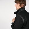 Fitted varsity jacket, wool-blend, snap closure, and artificial leather shoulder details and under collar.