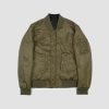 Reversible flight jacket, featuring black and olive green nylon with brass hardware.