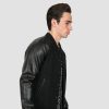 Volume fitted varsity jacket, wool-blend, snap closure, and artificial leather raglan sleeves.