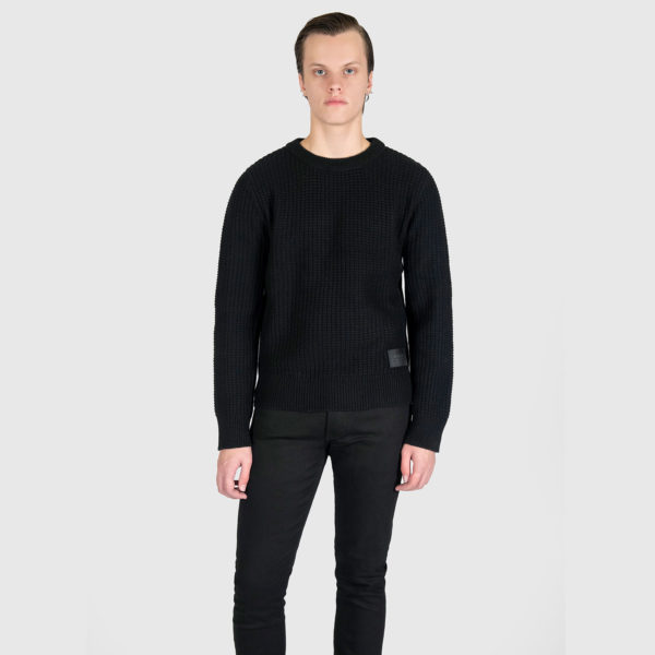 Black sweater with a military-inspired knitting pattern and black on black leather logo patch.