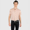 Short sleeve button up pink shirt with black polka dots.