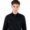 Long sleeve button up black western shirt with fringe and snap closure.