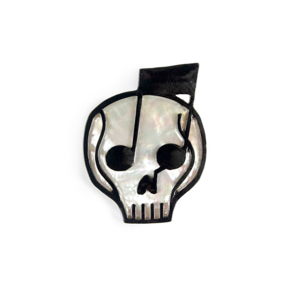 A skull and music note combine to make the pearl and black Harlow lapel pin.