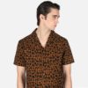 Short sleeve button up camp shirt with leopard print and spread collar.
