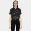 Short sleeve button up black shirt with white polka dots.