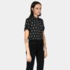 Short sleeve button up black shirt with white polka dots.