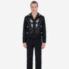 The Wilder is a black gabardine jacket with western details. It features white and metallic gold embroidery in a floral and star pattern.