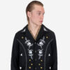 The Wilder is a black gabardine jacket with western details. It features white and metallic gold embroidery in a floral and star pattern.