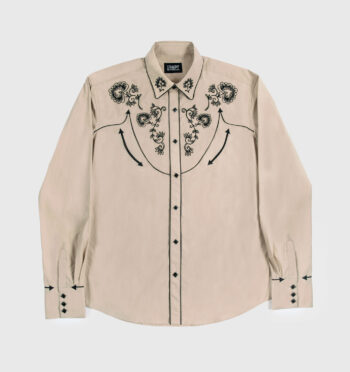 The Hudson is a beige, long-sleeve western shirt with floral embroidery. It also features black piping detail, pocket embroidery, and diamond snap closure.