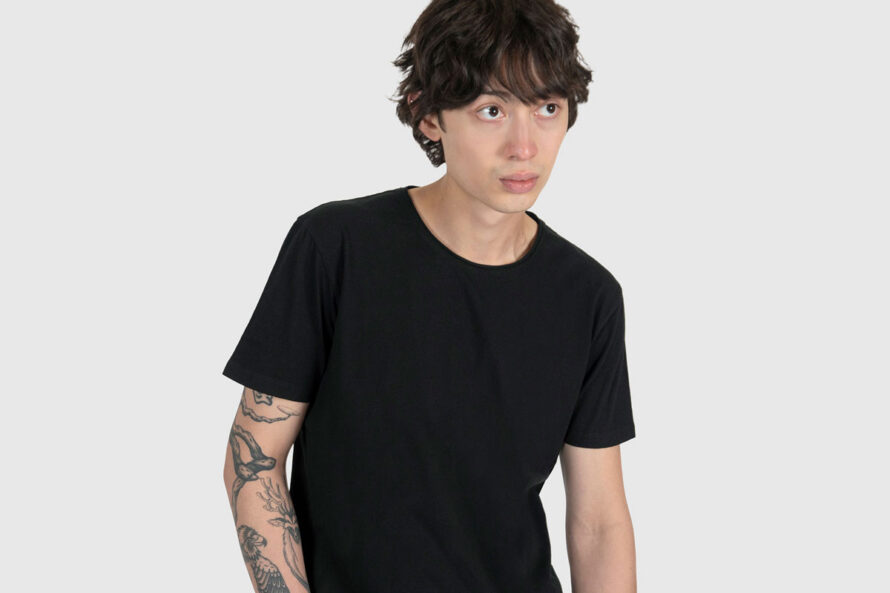 man wearing black linen t-shirt with raw neck