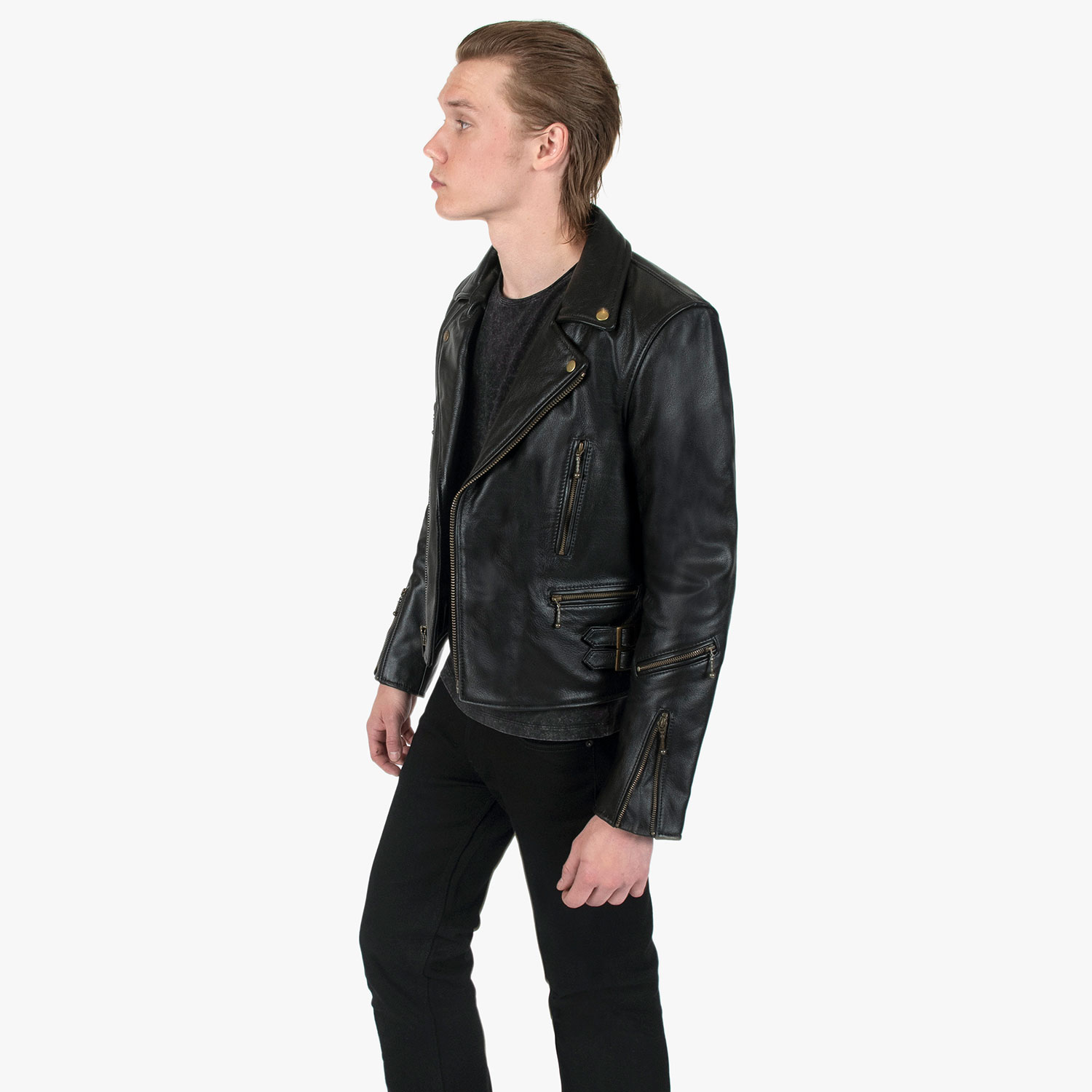 The Defector leather jacket combines old school style with stand-out features, notably a forearm zipper, silver ball pull zippers, side straps, and a curved hem.