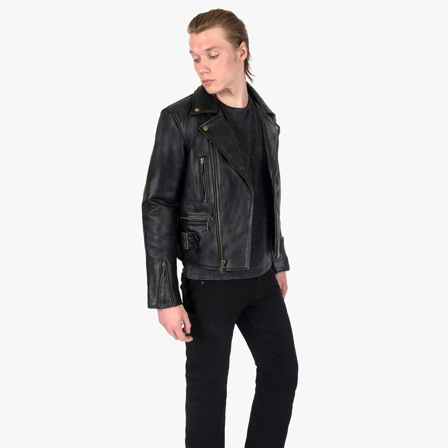 The Defector leather jacket combines old school style with stand-out features, notably a forearm zipper, silver ball pull zippers, side straps, and a curved hem.