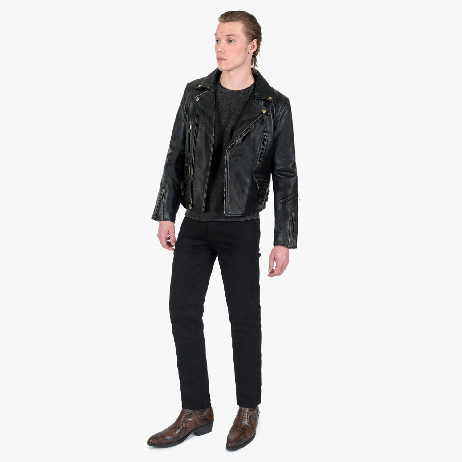 The Defector leather jacket combines old school style with stand-out features, notably a forearm zipper, brass ball pull zippers, side straps, and a curved hem.