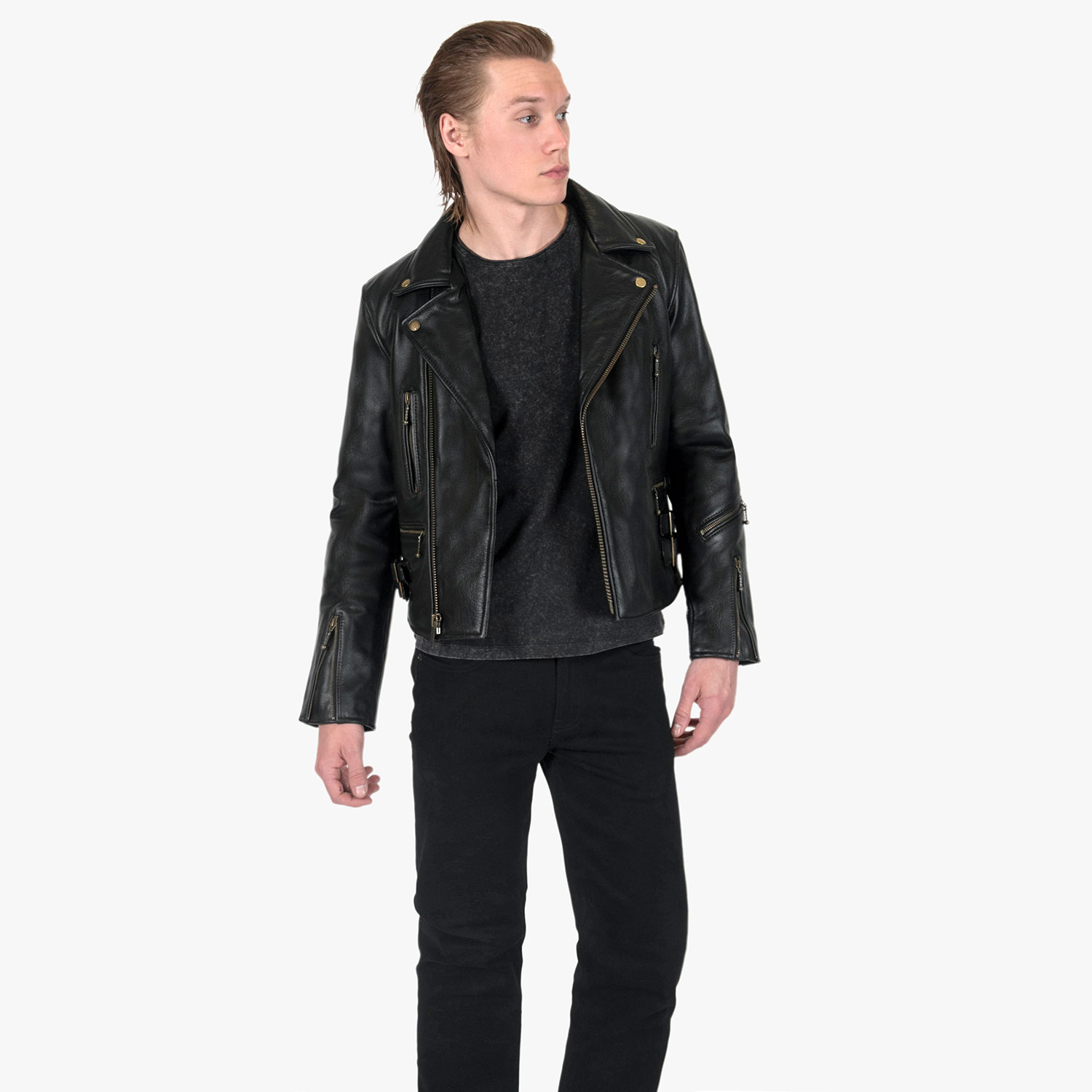 The Defector leather jacket combines old school style with stand-out features, notably a forearm zipper, brass ball pull zippers, side straps, and a curved hem.