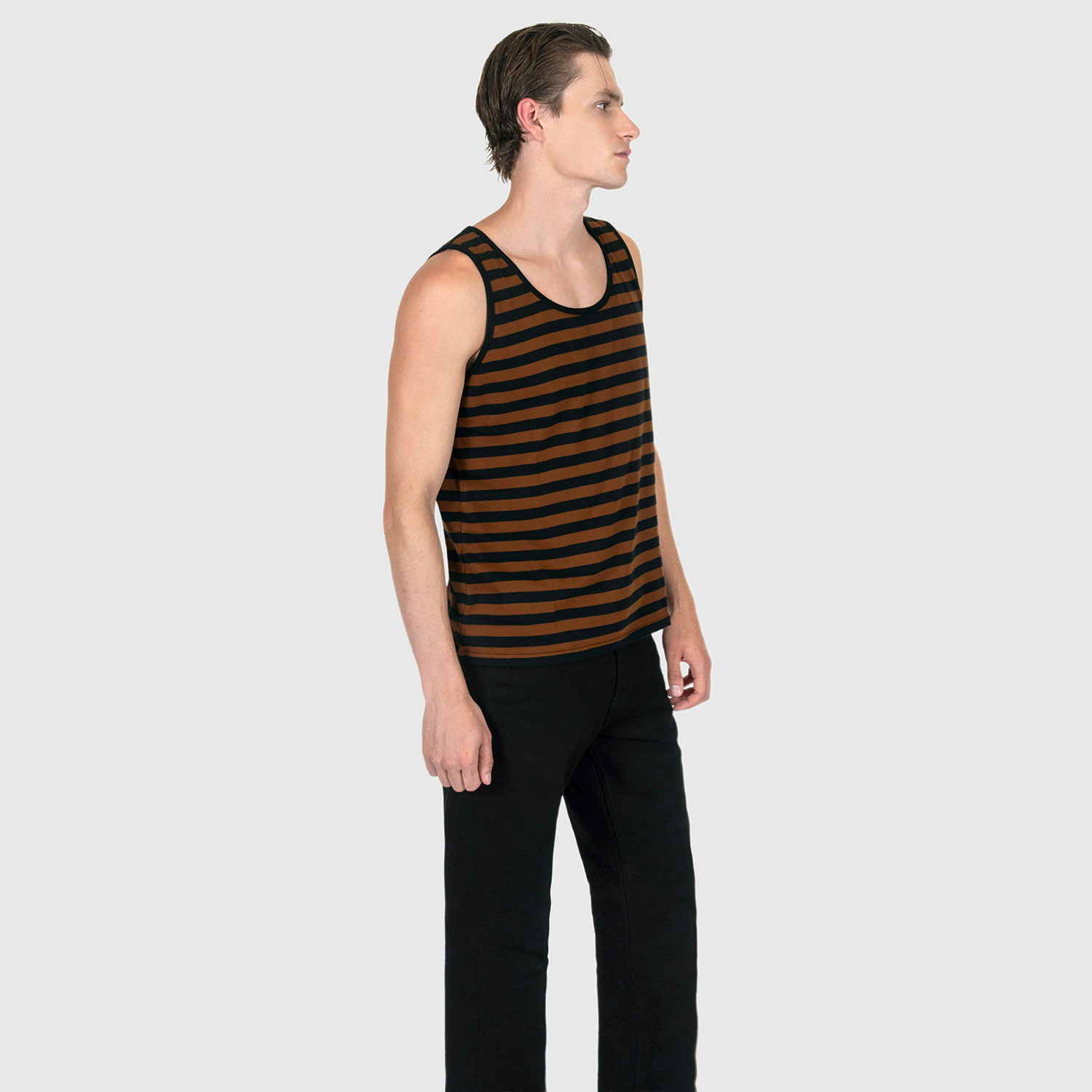 The Richie is a black and brown, short sleeve striped tank top. This soft cotton-poly blend allows the fabric to drape comfortably on your torso. It features a subtle diamond embroidered on the lower corner. This is our Bucktown fit.