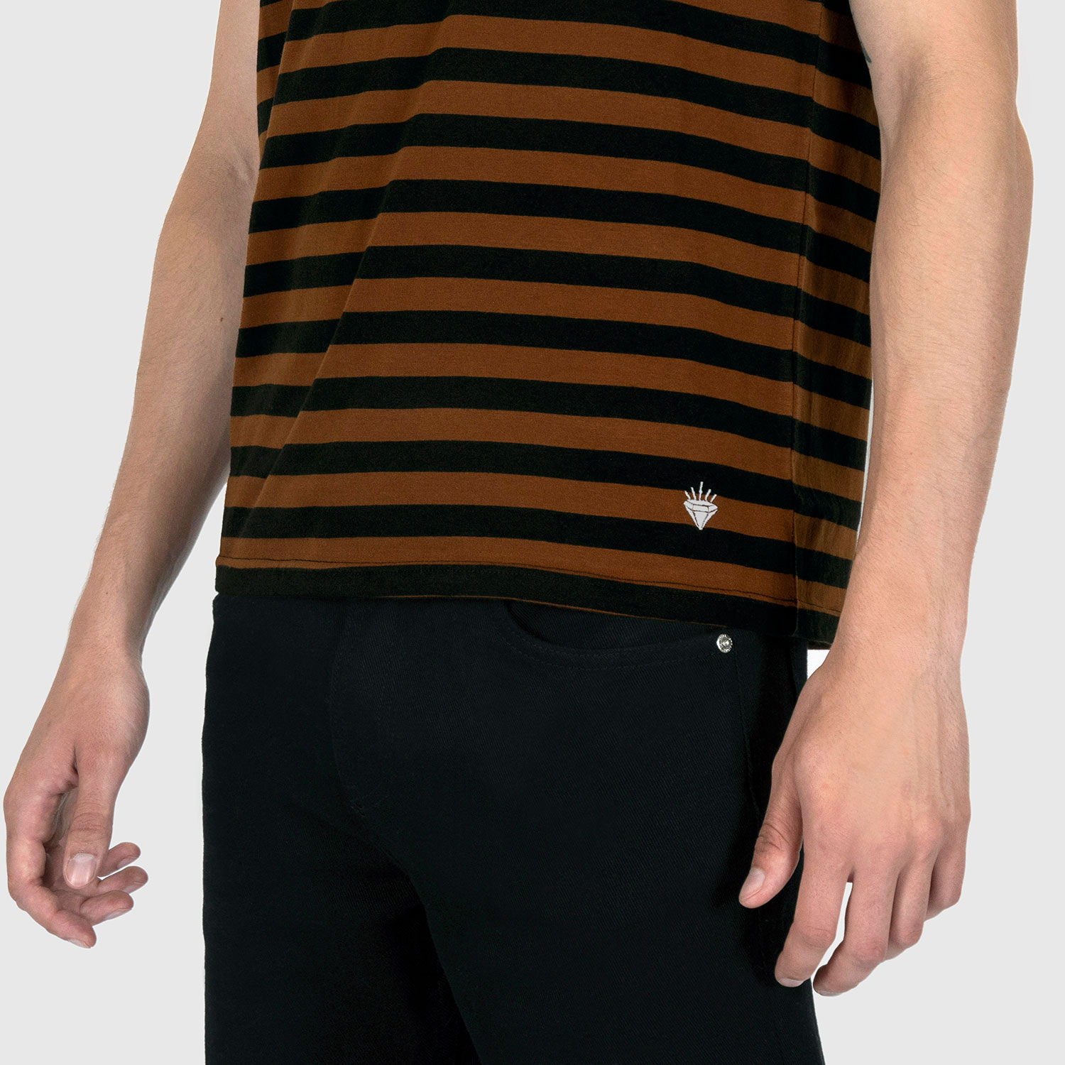 The Richie is a black and brown, short sleeve striped tank top. This soft cotton-poly blend allows the fabric to drape comfortably on your torso. It features a subtle diamond embroidered on the lower corner. This is our Bucktown fit.