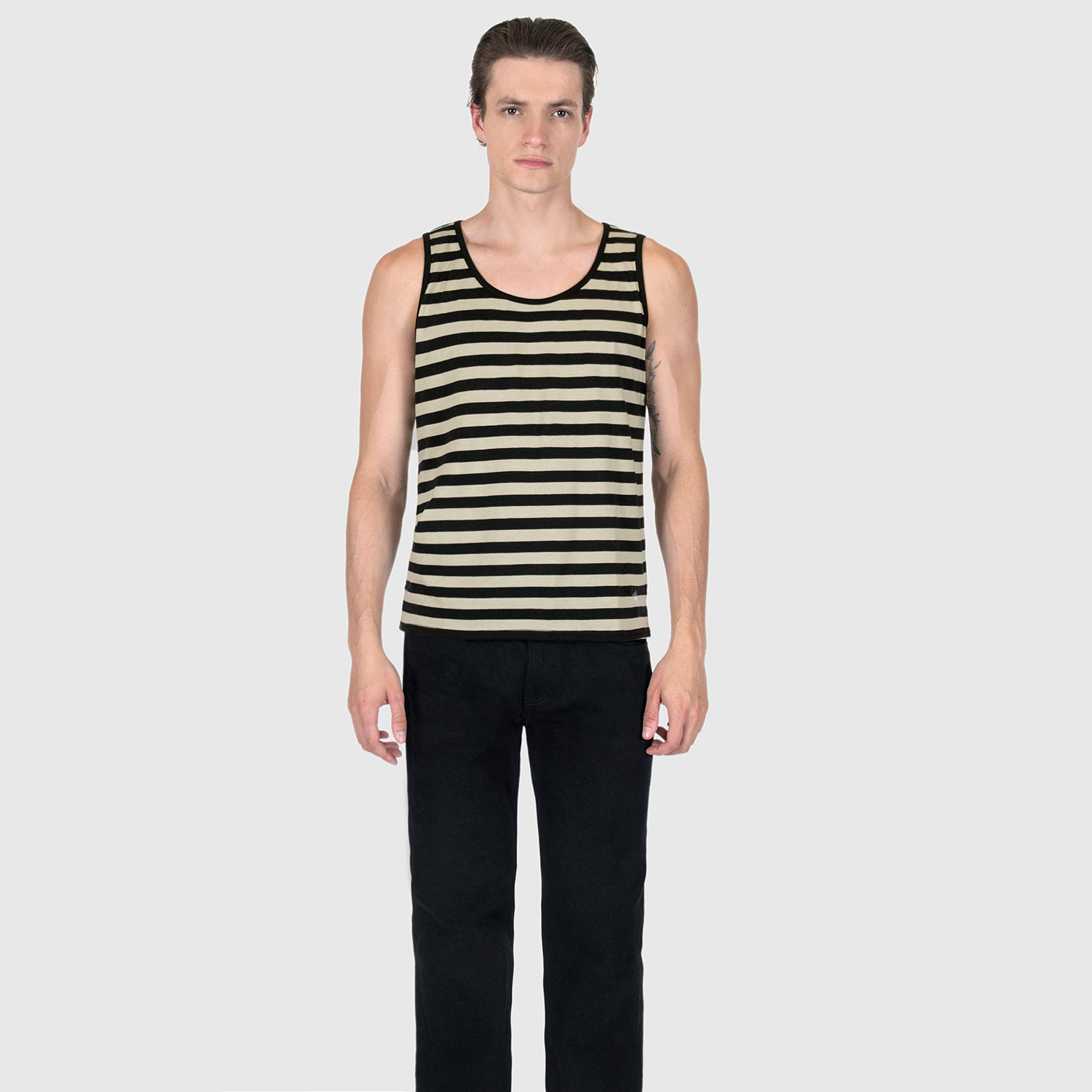 The Richie is a black and cream, short sleeve striped tank top. This soft cotton-poly blend allows the fabric to drape comfortably on your torso. It features a subtle diamond embroidered on the lower corner. This is our Bucktown fit.