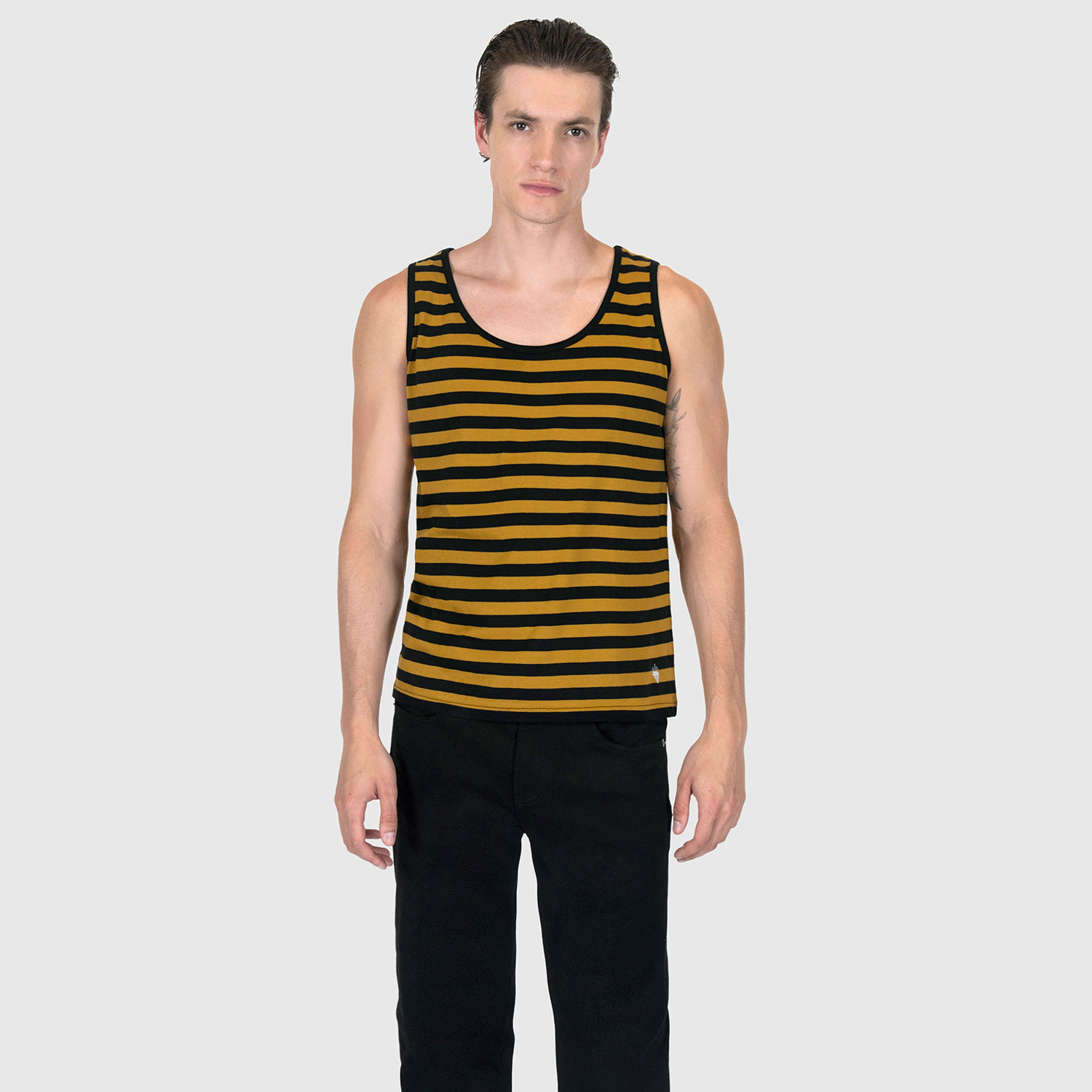 The Richie is a black and yellow striped tank top. This soft cotton-poly blend allows the fabric to drape comfortably on your torso. It features a subtle diamond embroidered on the lower corner.