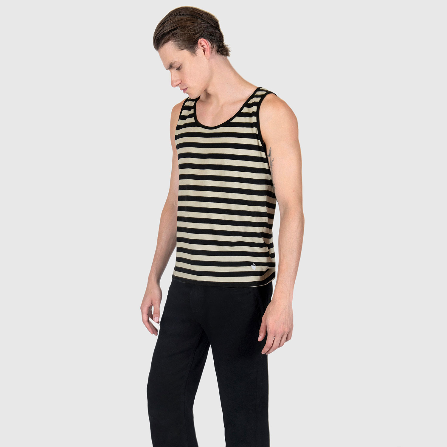 The Richie is a black and cream, short sleeve striped tank top. This soft cotton-poly blend allows the fabric to drape comfortably on your torso. It features a subtle diamond embroidered on the lower corner. This is our Bucktown fit.