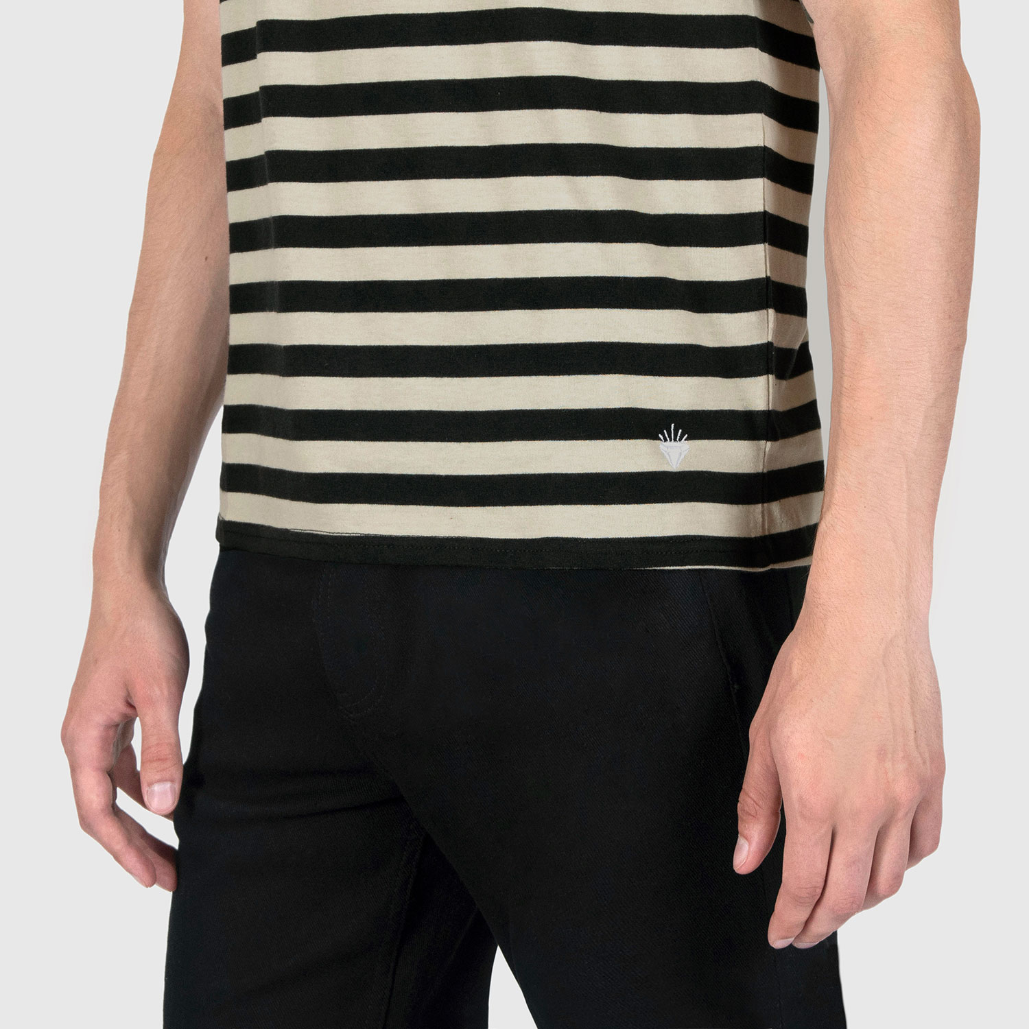 The Richie is a black and cream, short sleeve striped tank top. This soft cotton-poly blend allows the fabric to drape comfortably on your torso. It features a subtle diamond embroidered on the lower corner. This is our Bucktown fit.