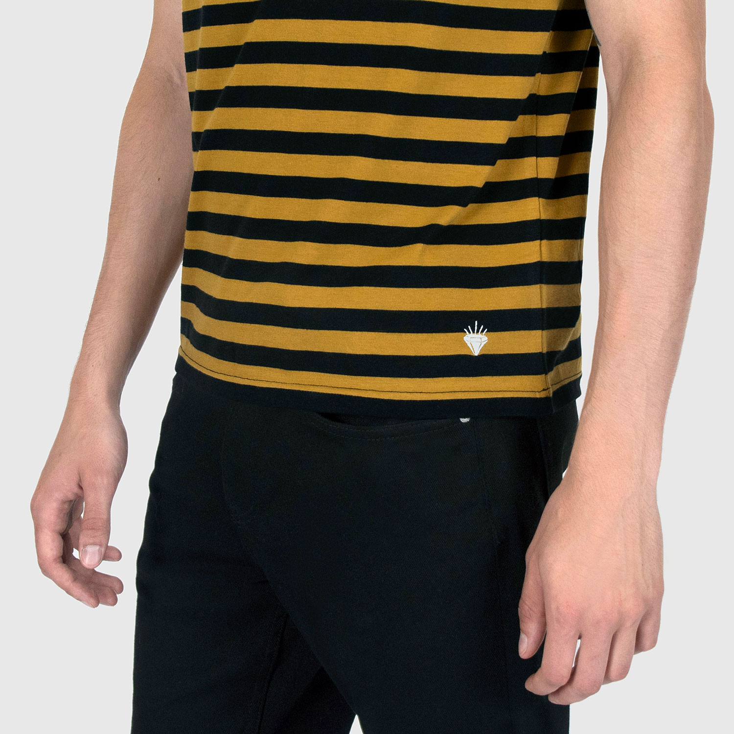 The Richie is a black and yellow striped tank top. This soft cotton-poly blend allows the fabric to drape comfortably on your torso. It features a subtle diamond embroidered on the lower corner.