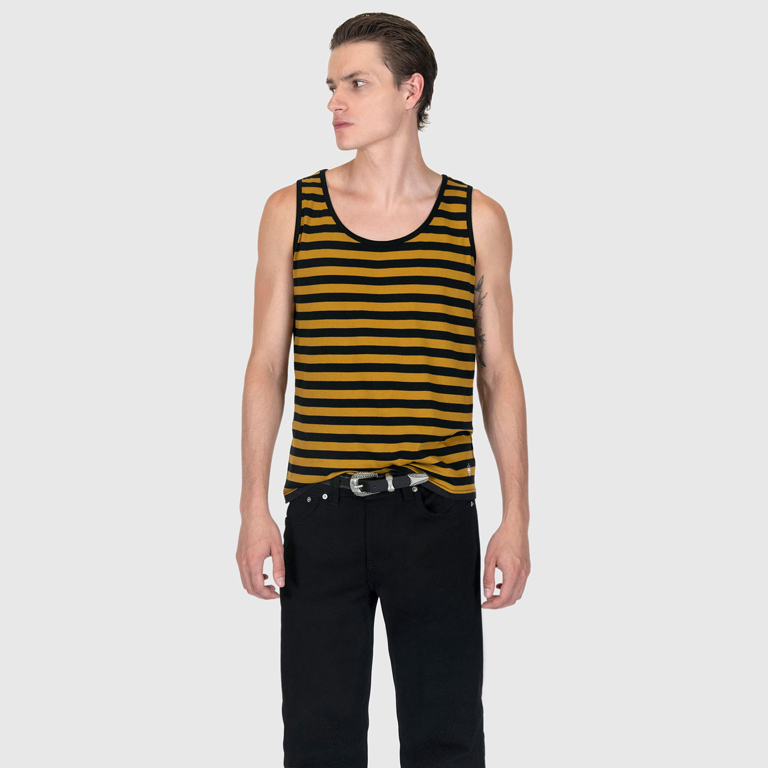The Richie is a black and yellow striped tank top. This soft cotton-poly blend allows the fabric to drape comfortably on your torso. It features a subtle diamond embroidered on the lower corner.