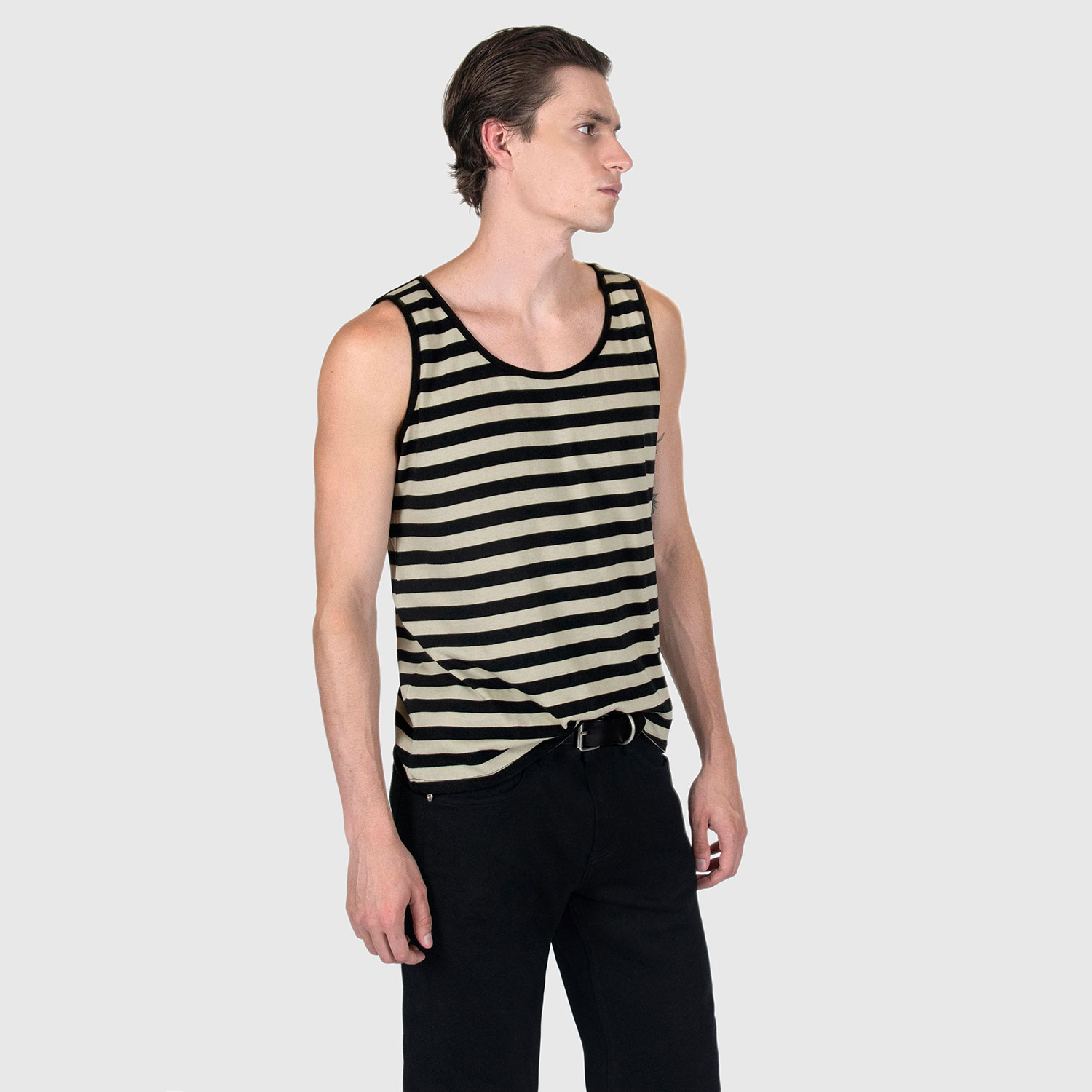 The Richie is a black and cream, short sleeve striped tank top. This soft cotton-poly blend allows the fabric to drape comfortably on your torso. It features a subtle diamond embroidered on the lower corner. This is our Bucktown fit.