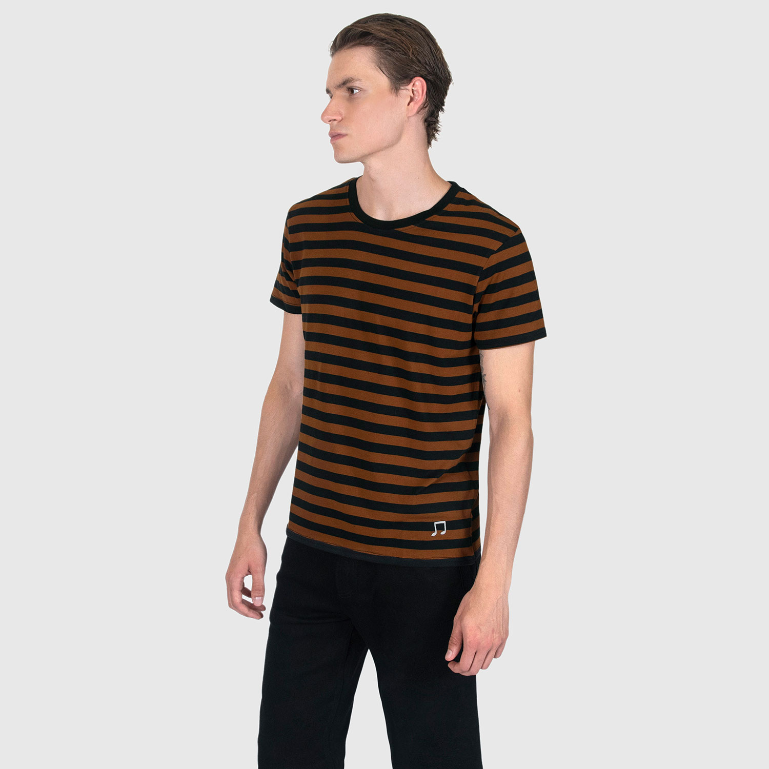 The Teddy is a black and yellow, short sleeve striped t-shirt. This soft cotton-poly blend allows the fabric to drape comfortably on your torso. It features a subtle music note embroidered on the lower corner. This is our Bucktown fit.
