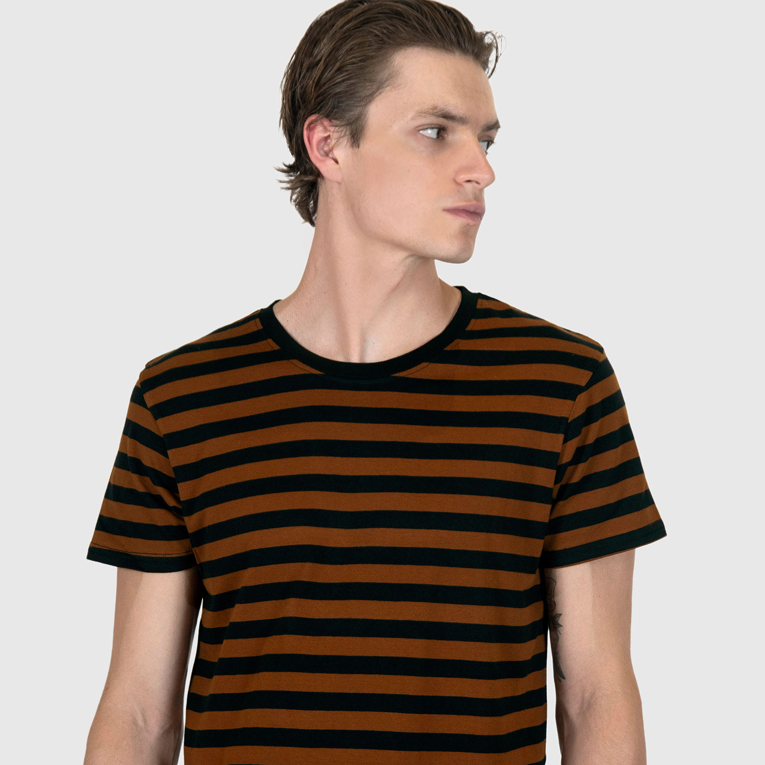 The Teddy is a black and yellow, short sleeve striped t-shirt. This soft cotton-poly blend allows the fabric to drape comfortably on your torso. It features a subtle music note embroidered on the lower corner. This is our Bucktown fit.