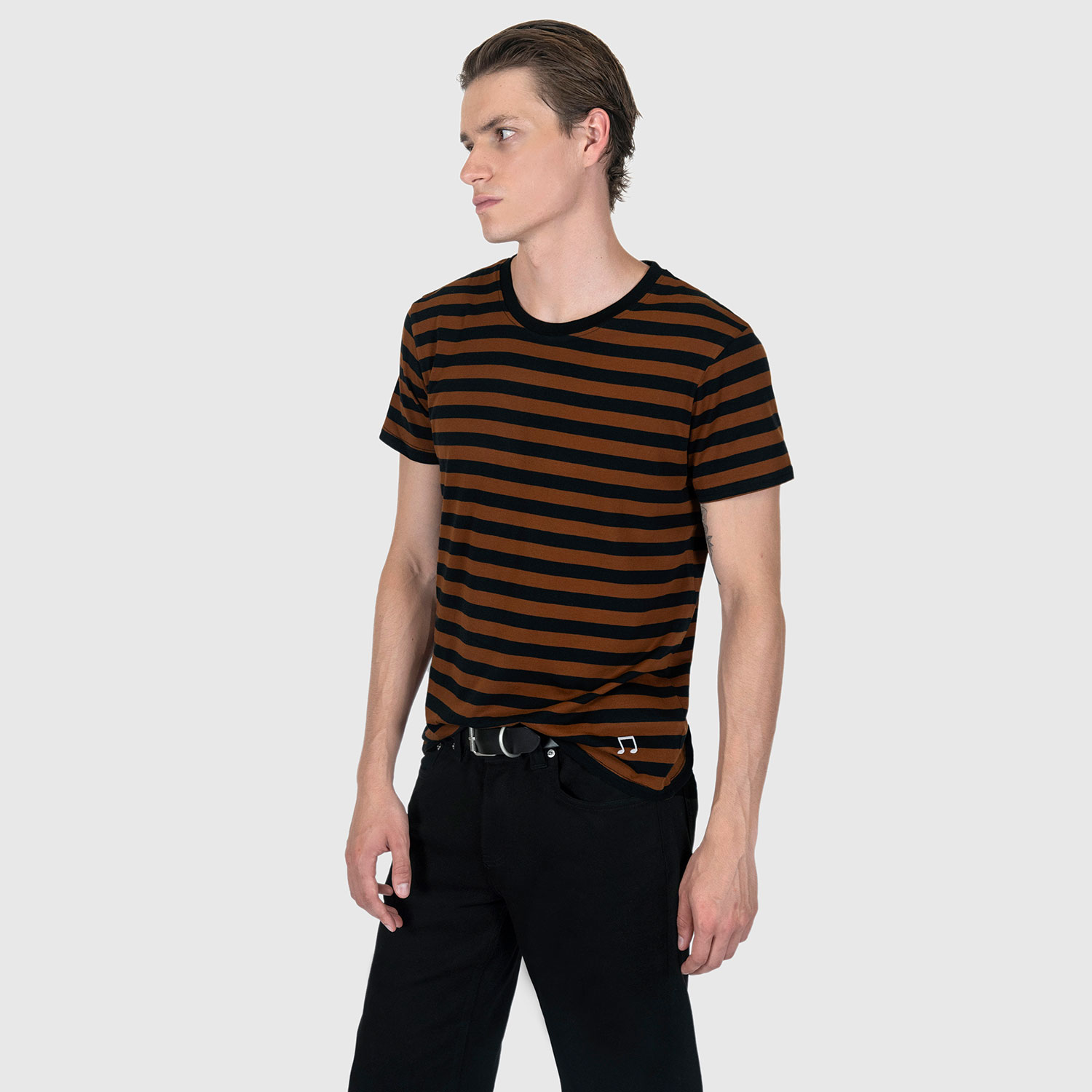 The Teddy is a black and yellow, short sleeve striped t-shirt. This soft cotton-poly blend allows the fabric to drape comfortably on your torso. It features a subtle music note embroidered on the lower corner. This is our Bucktown fit.