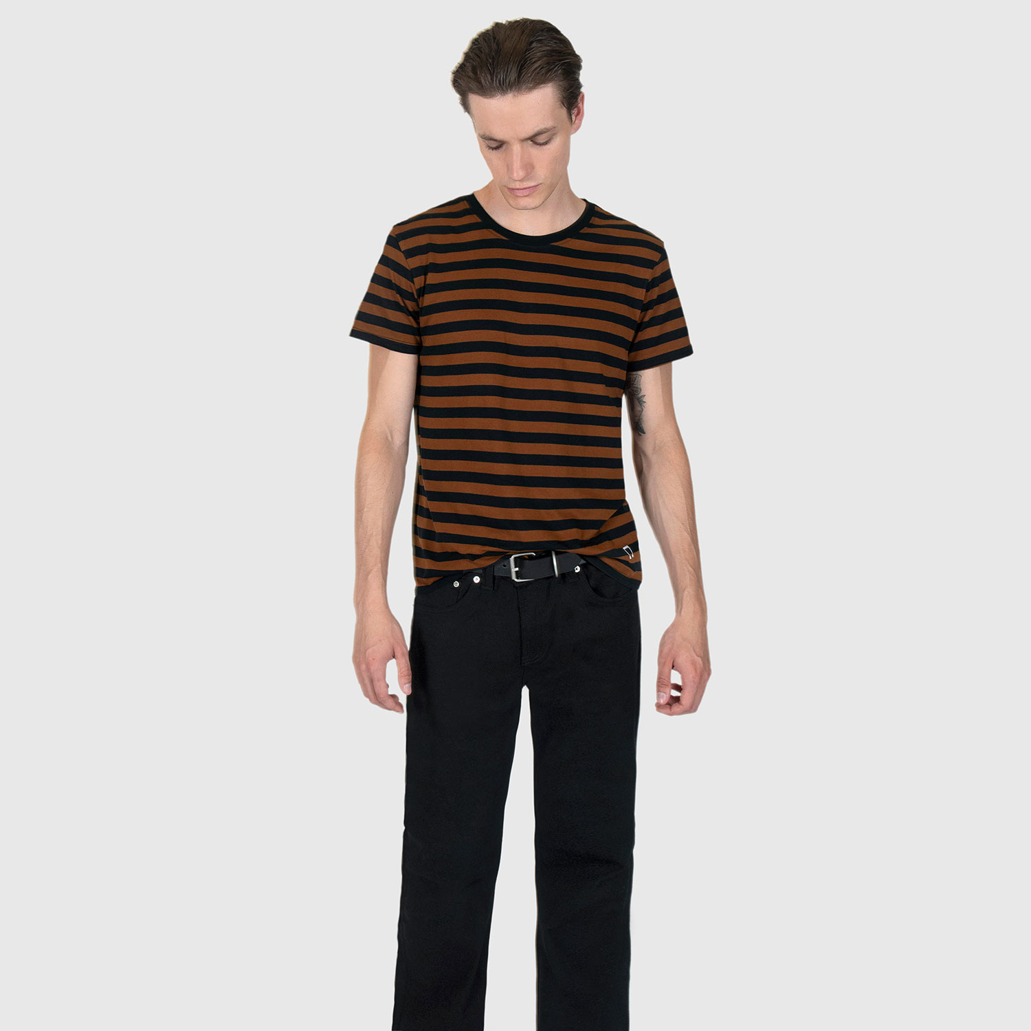 The Teddy is a black and yellow, short sleeve striped t-shirt. This soft cotton-poly blend allows the fabric to drape comfortably on your torso. It features a subtle music note embroidered on the lower corner. This is our Bucktown fit.