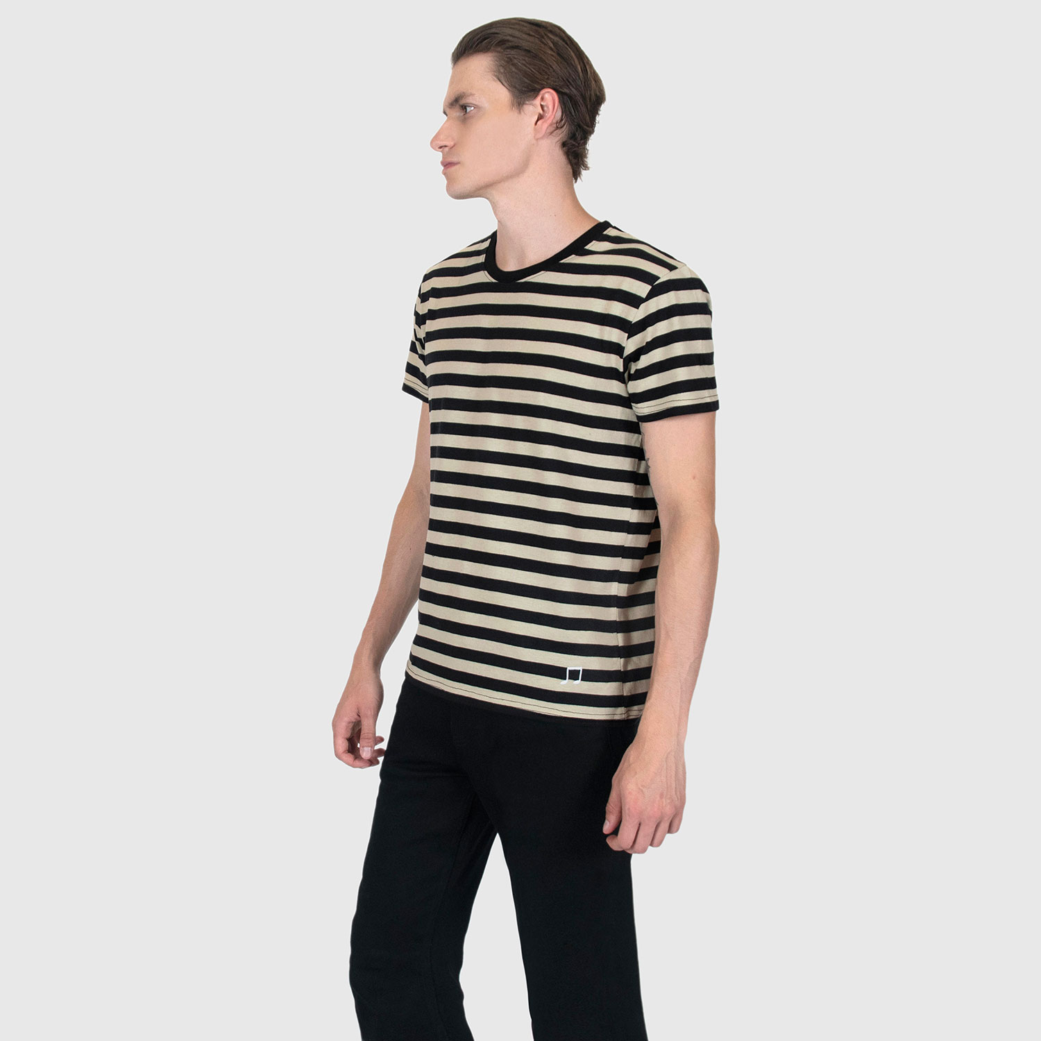 The Teddy is a black and cream, short sleeve striped t-shirt. This soft cotton-poly blend allows the fabric to drape comfortably on your torso. It features a subtle music note embroidered on the lower corner. This is our Bucktown fit.
