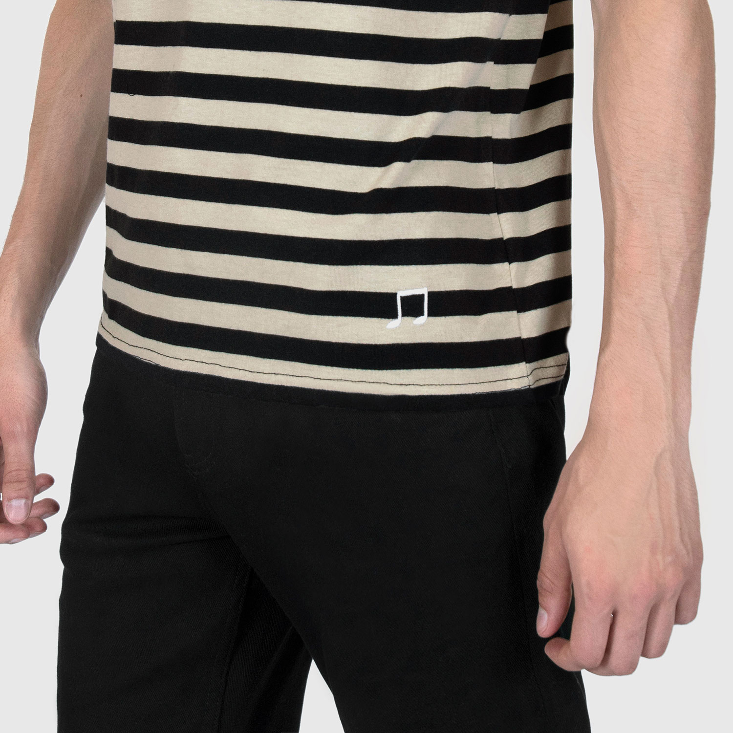 The Teddy is a black and cream, short sleeve striped t-shirt. This soft cotton-poly blend allows the fabric to drape comfortably on your torso. It features a subtle music note embroidered on the lower corner. This is our Bucktown fit.