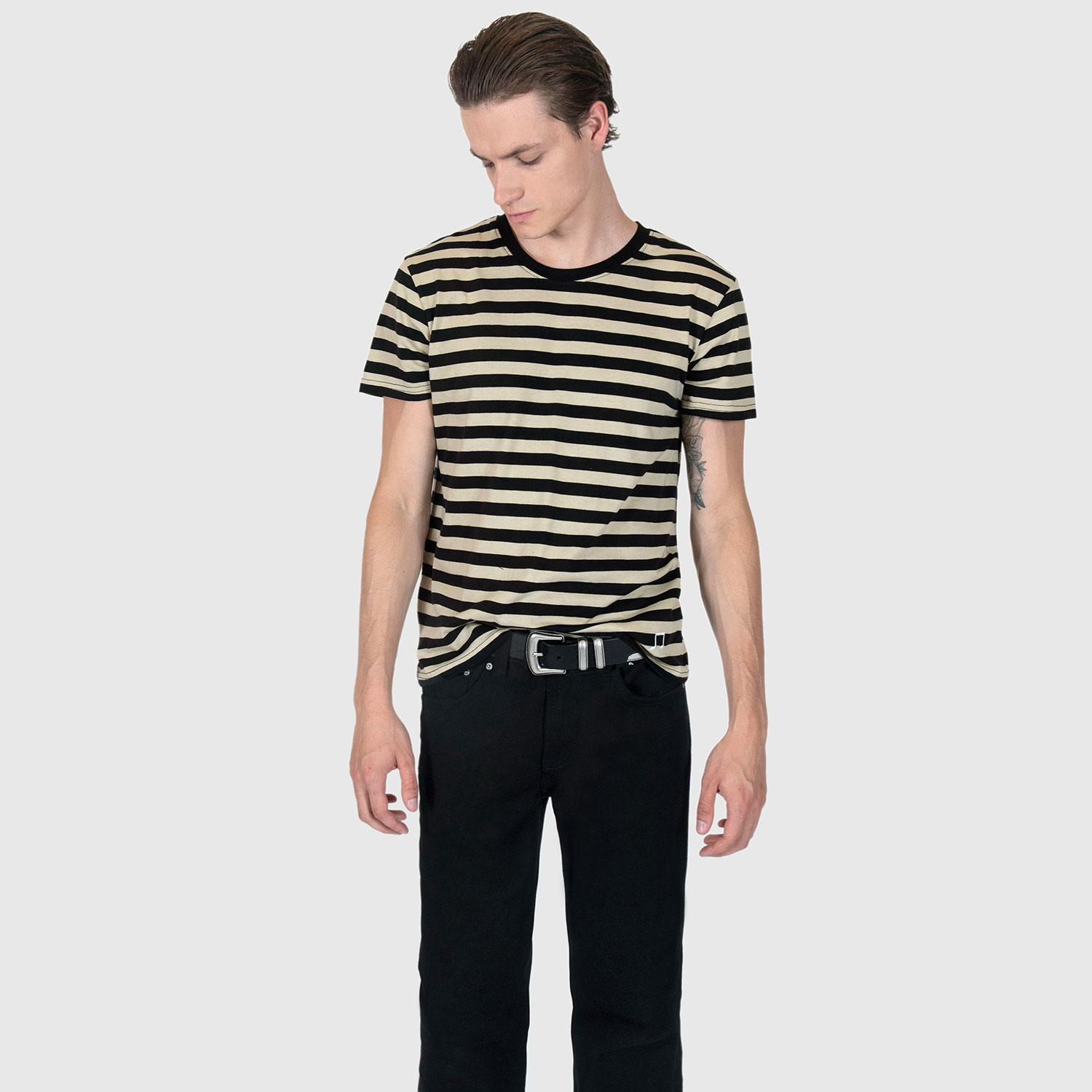 The Teddy is a black and cream, short sleeve striped t-shirt. This soft cotton-poly blend allows the fabric to drape comfortably on your torso. It features a subtle music note embroidered on the lower corner. This is our Bucktown fit.