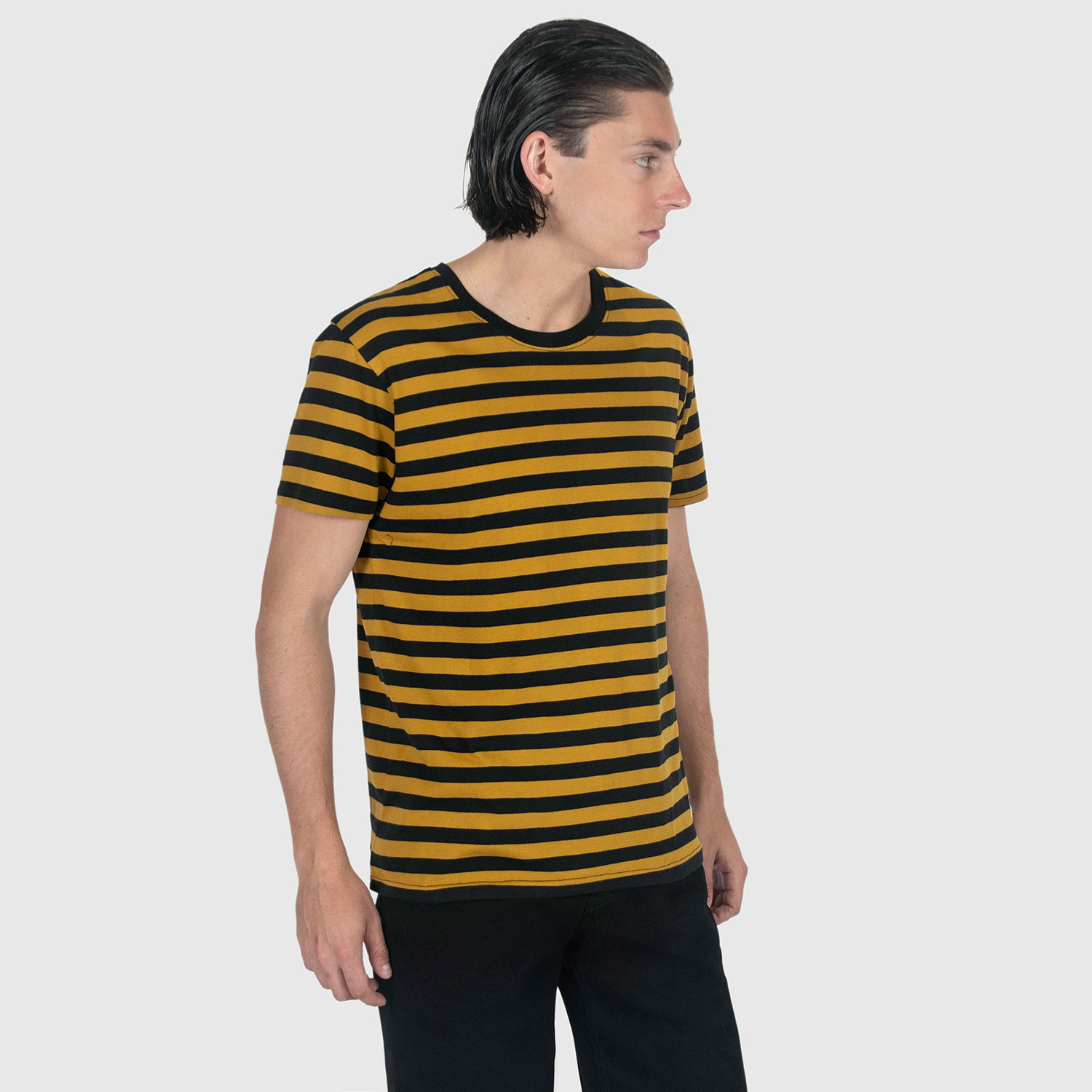 The Teddy is a black and yellow, short sleeve striped t-shirt. This soft cotton-poly blend allows the fabric to drape comfortably on your torso. This is our Bucktown fit.
