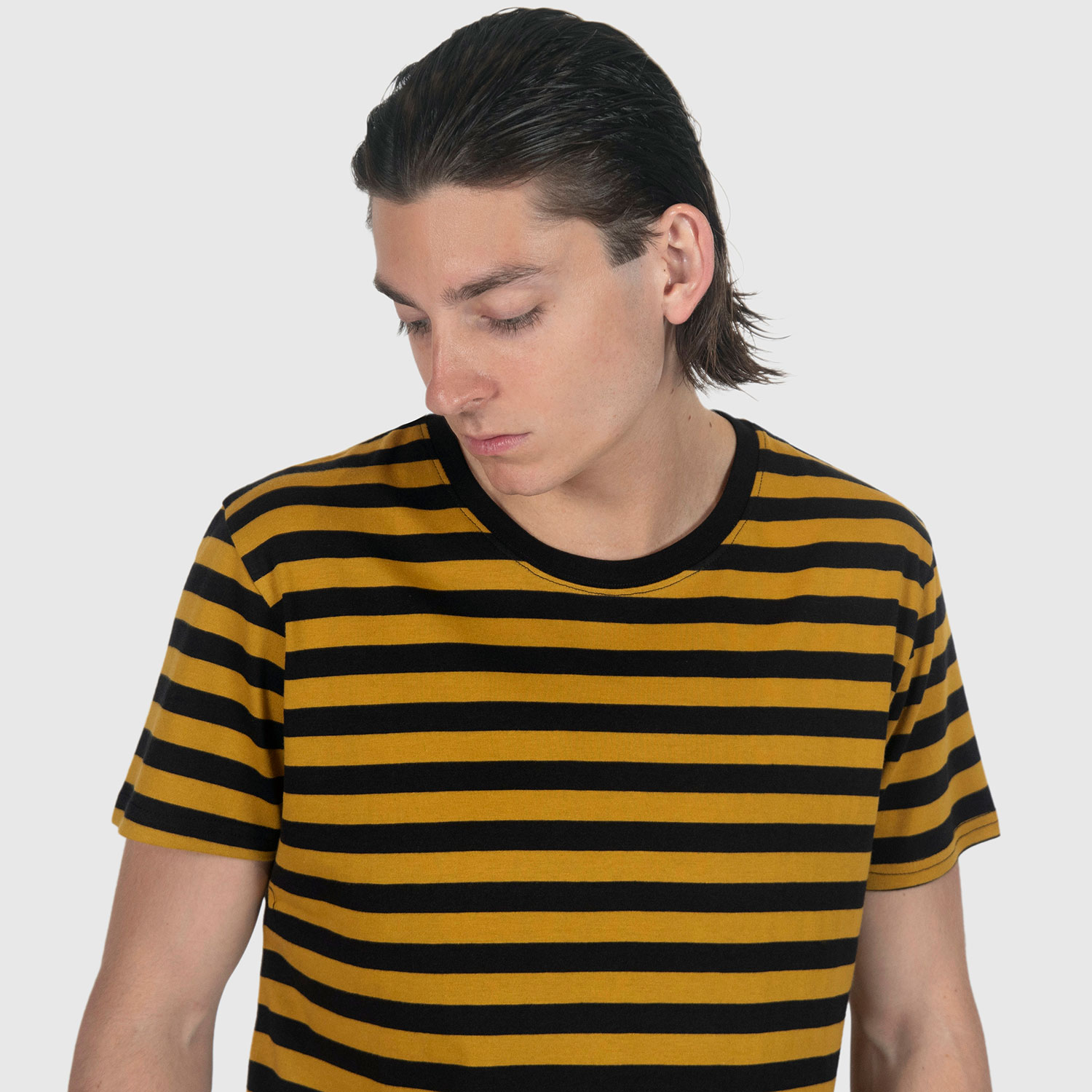 The Teddy is a black and yellow, short sleeve striped t-shirt. This soft cotton-poly blend allows the fabric to drape comfortably on your torso. This is our Bucktown fit.