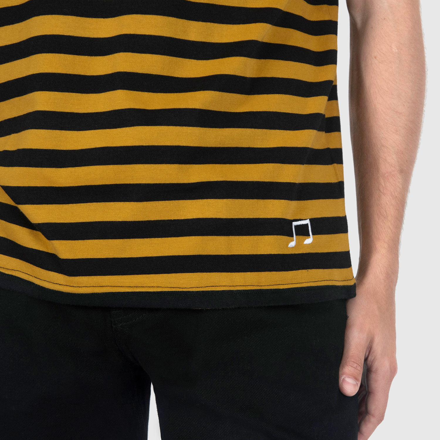 The Teddy is a black and yellow, short sleeve striped t-shirt. This soft cotton-poly blend allows the fabric to drape comfortably on your torso. This is our Bucktown fit.