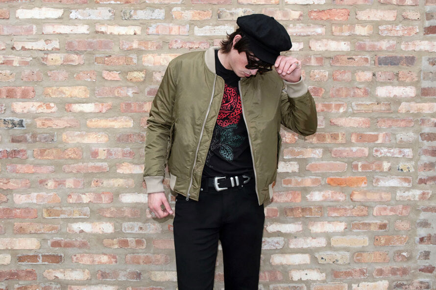 A nylon flight jacket with contrast ribbed elastic and silver hardware. The olive and sage green color combination gives this classic bomber style a more distinctive look. Side pockets and classic utility bicep pocket with STH woven label. An easy layer for when you want the structure of a jacket without the weight of a heavy coat. This is our Proper fit.