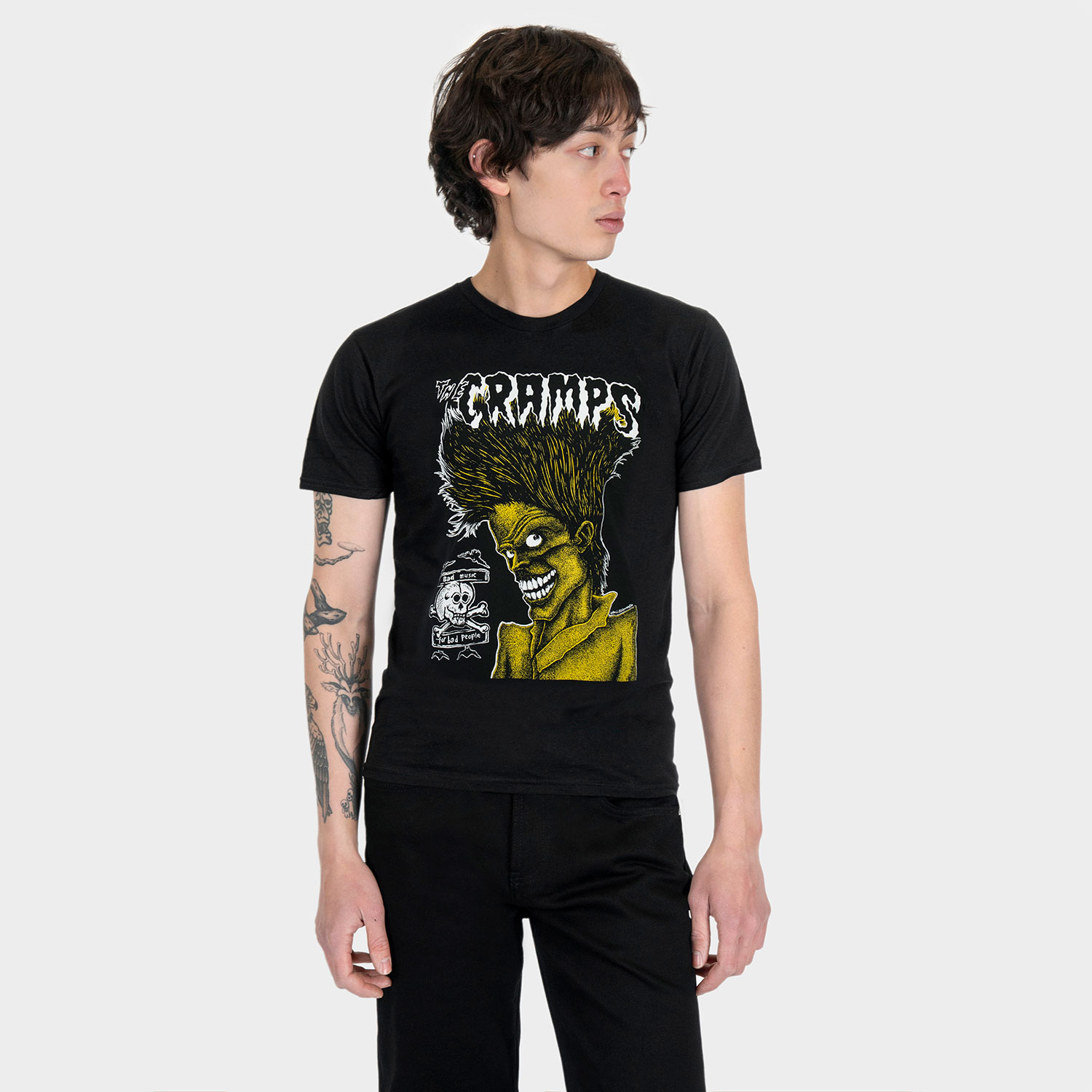 The Cramps official t-shirts are here for a limited time. Bad Music for Bad People goes hard, pulling artwork from the front and back of this perfect record featuring the unmistakable likeness of singer Lux Interior. We also mixed the cover art with mid-’80s promotional Cramps imagery. When your rotation needs something louder, this tee has you covered. Made from soft cotton and printed in-house in Chicago. This is our Everyday fit. Available with a single-sided front print or go double-sided with artwork on the front and back. Let’s talk about The Cramps and their shocking sound. Trashy, primitive punk and garage rock collide with raw R&B, fuzzed-out rockabilly gone wrong, B-movie sleaze, and ’50s rock ‘n’ roll dragged through the gutter. Do you get it now? Good.