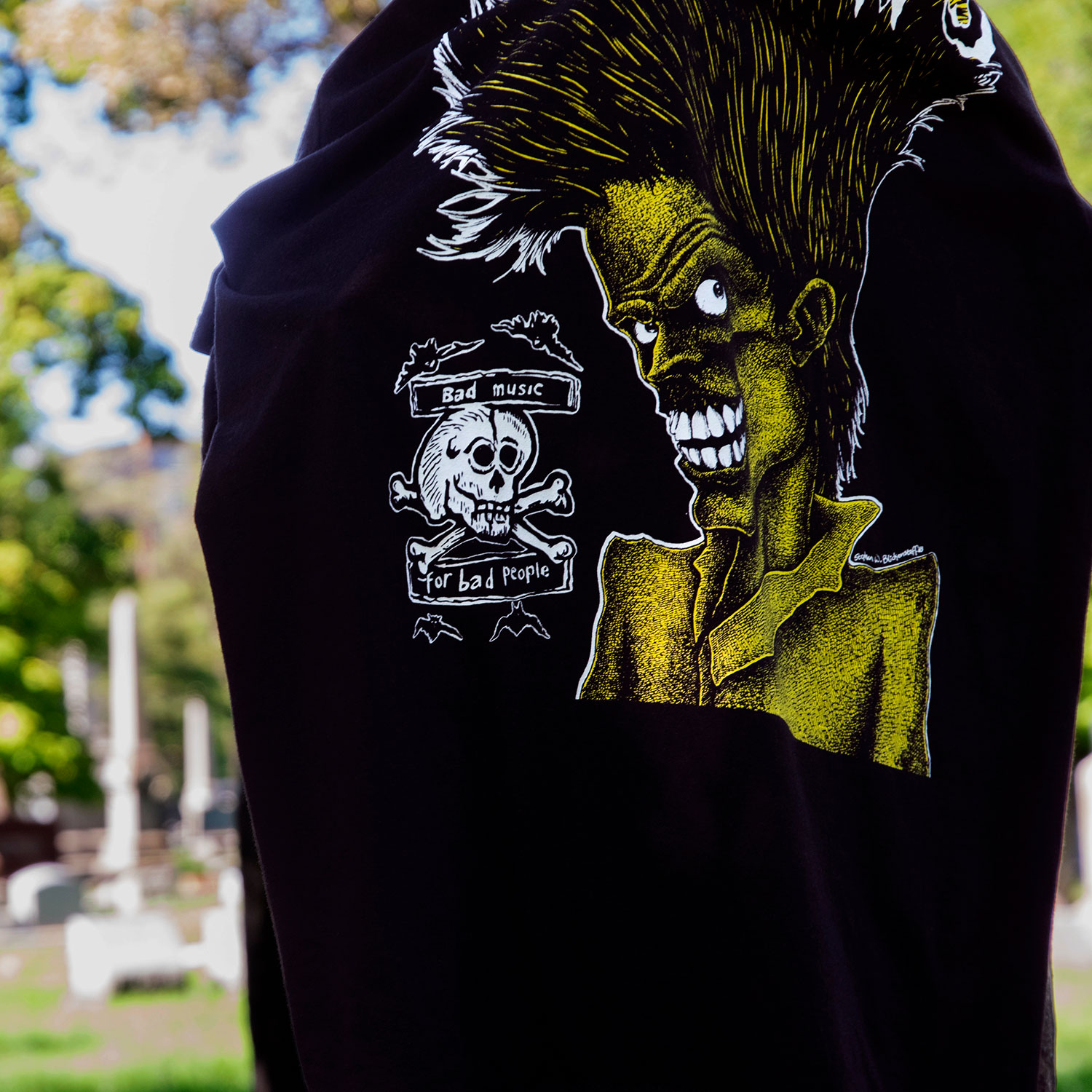 The Cramps official t-shirts are here for a limited time. Bad Music for Bad People goes hard, pulling artwork from the front and back of this perfect record featuring the unmistakable likeness of singer Lux Interior. We also mixed the cover art with mid-’80s promotional Cramps imagery. When your rotation needs something louder, this tee has you covered. Made from soft cotton and printed in-house in Chicago. This is our Everyday fit. Available with a single-sided front print or go double-sided with artwork on the front and back. Let’s talk about The Cramps and their shocking sound. Trashy, primitive punk and garage rock collide with raw R&B, fuzzed-out rockabilly gone wrong, B-movie sleaze, and ’50s rock ‘n’ roll dragged through the gutter. Do you get it now? Good.