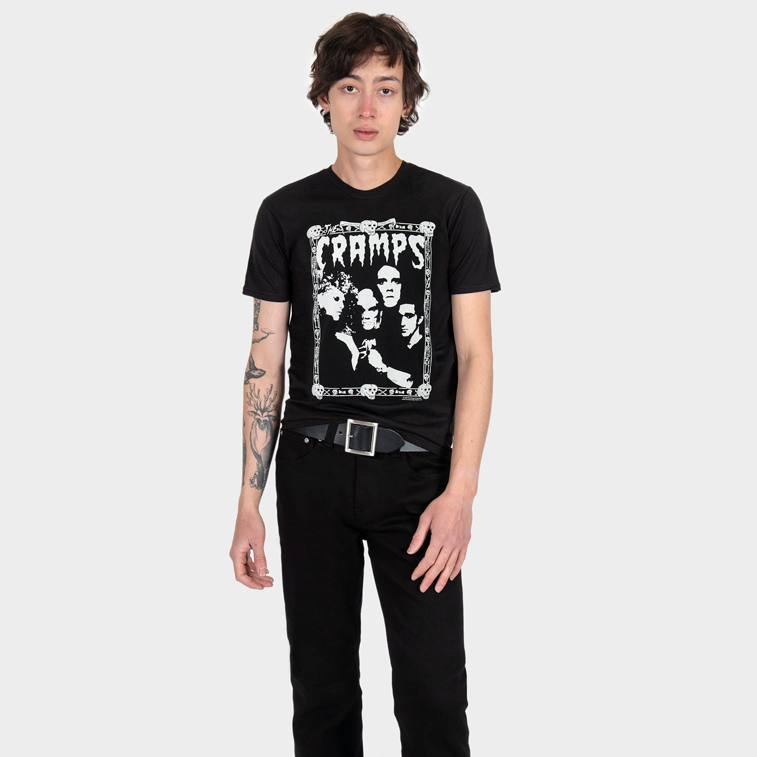 The Cramps official t-shirts are here for a limited time. Artwork from their debut album, Songs the Lord Taught Us, goes big inside the band’s classic skull-and-bones Too Bad You’re Gonna Die border. For The Cramps fan who appreciates more than the average band tee, this one delivers in black and white. Made from soft cotton and printed in-house in Chicago. This is our Everyday fit. Let’s talk about The Cramps and their shocking sound. Trashy, primitive punk and garage rock collide with raw R&B, fuzzed-out rockabilly gone wrong, B-movie sleaze, and ’50s rock ‘n’ roll dragged through the gutter. Do you get it now? Good.
