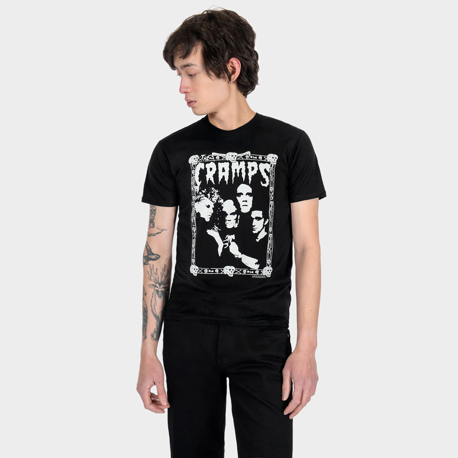 The Cramps official t-shirts are here for a limited time. Artwork from their debut album, Songs the Lord Taught Us, goes big inside the band’s classic skull-and-bones Too Bad You’re Gonna Die border. For The Cramps fan who appreciates more than the average band tee, this one delivers in black and white. Made from soft cotton and printed in-house in Chicago. This is our Everyday fit. Let’s talk about The Cramps and their shocking sound. Trashy, primitive punk and garage rock collide with raw R&B, fuzzed-out rockabilly gone wrong, B-movie sleaze, and ’50s rock ‘n’ roll dragged through the gutter. Do you get it now? Good.