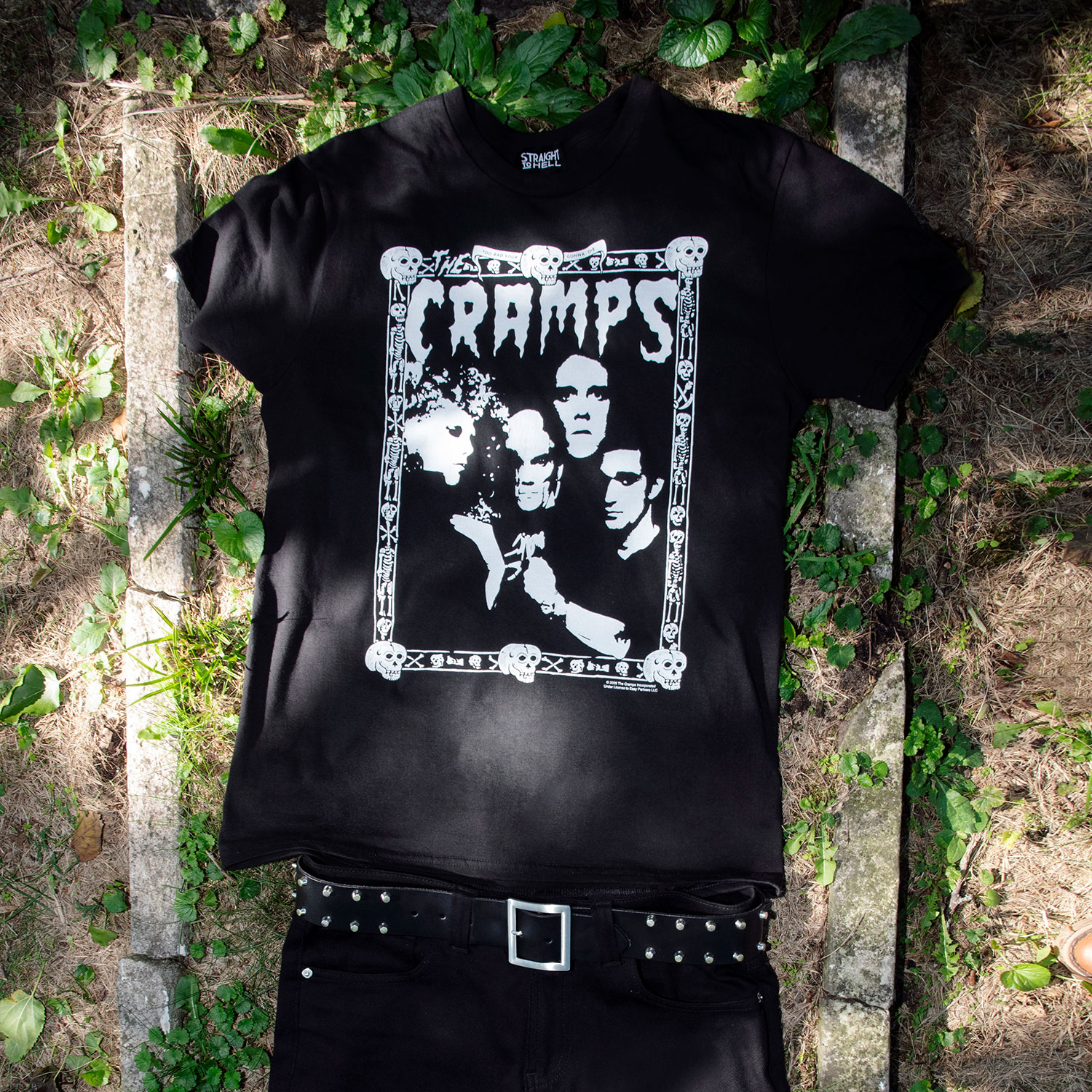 The Cramps official t-shirts are here for a limited time. Artwork from their debut album, Songs the Lord Taught Us, goes big inside the band’s classic skull-and-bones Too Bad You’re Gonna Die border. For The Cramps fan who appreciates more than the average band tee, this one delivers in black and white. Made from soft cotton and printed in-house in Chicago. This is our Everyday fit. Let’s talk about The Cramps and their shocking sound. Trashy, primitive punk and garage rock collide with raw R&B, fuzzed-out rockabilly gone wrong, B-movie sleaze, and ’50s rock ‘n’ roll dragged through the gutter. Do you get it now? Good.