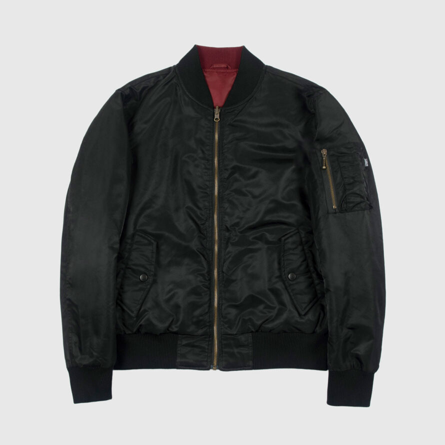 Reversible flight jacket, featuring black and burgundy nylon with brass hardware. Two different color styles in one jacket, so you’ve always got another option. Side pockets and classic utility bicep pocket with STH woven label. Durable elastic cuffs, waistband, and neck. This is our Proper fit.