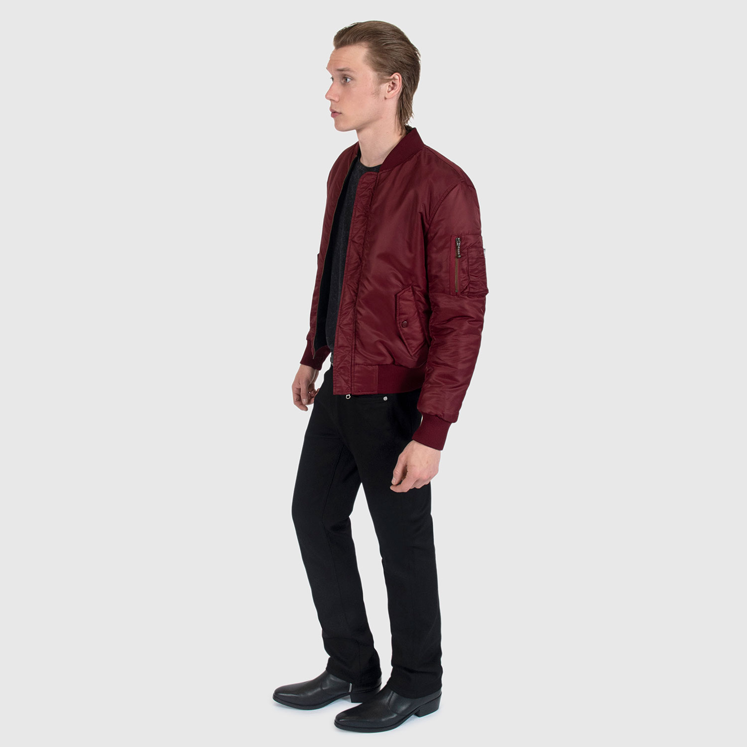 Reversible flight jacket, featuring black and burgundy nylon with brass hardware. Two different color styles in one jacket, so you’ve always got another option. Side pockets and classic utility bicep pocket with STH woven label. Durable elastic cuffs, waistband, and neck. This is our Proper fit.