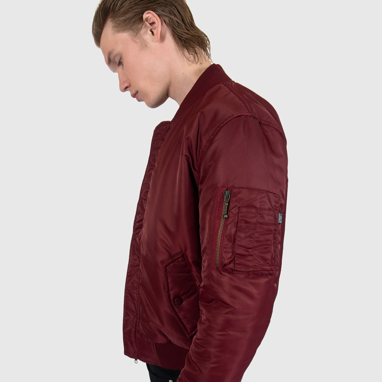 Reversible flight jacket, featuring black and burgundy nylon with brass hardware. Two different color styles in one jacket, so you’ve always got another option. Side pockets and classic utility bicep pocket with STH woven label. Durable elastic cuffs, waistband, and neck. This is our Proper fit.