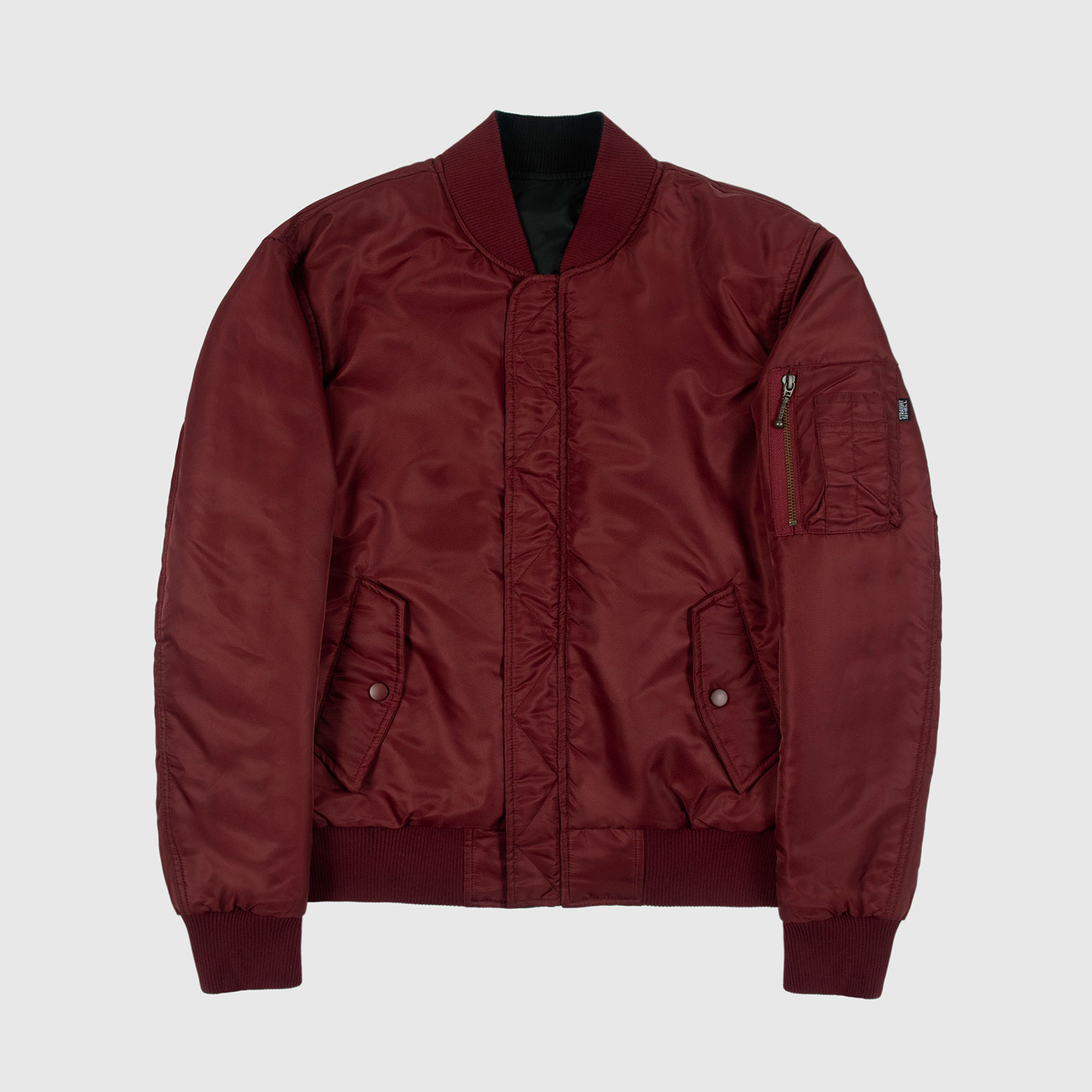 Reversible flight jacket, featuring black and burgundy nylon with brass hardware. Two different color styles in one jacket, so you’ve always got another option. Side pockets and classic utility bicep pocket with STH woven label. Durable elastic cuffs, waistband, and neck. This is our Proper fit.