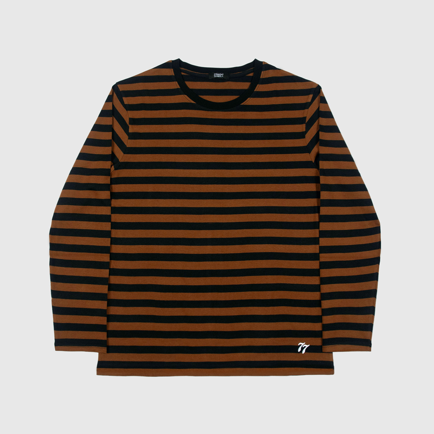 The Fitz 77 is a black and brown striped, long sleeve t-shirt. This soft cotton-poly blend allows the fabric to drape comfortably on your torso. It features a subtle 77 embroidered on the lower corner. This is our Bucktown fit.