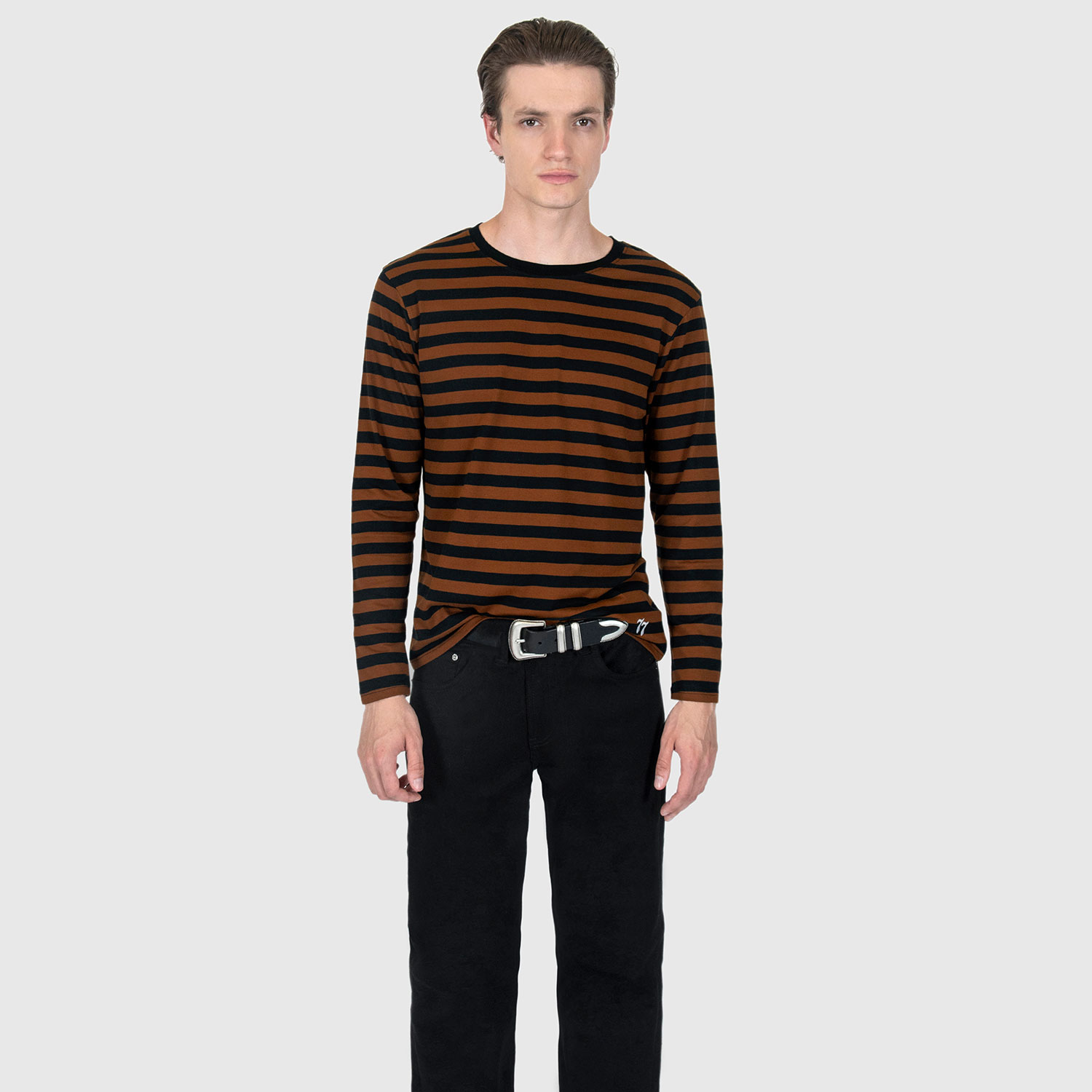 The Fitz 77 is a black and brown striped, long sleeve t-shirt. This soft cotton-poly blend allows the fabric to drape comfortably on your torso. It features a subtle 77 embroidered on the lower corner. This is our Bucktown fit.