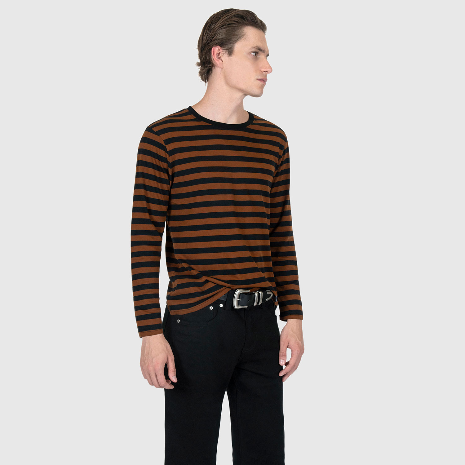 The Fitz 77 is a black and brown striped, long sleeve t-shirt. This soft cotton-poly blend allows the fabric to drape comfortably on your torso. It features a subtle 77 embroidered on the lower corner. This is our Bucktown fit.
